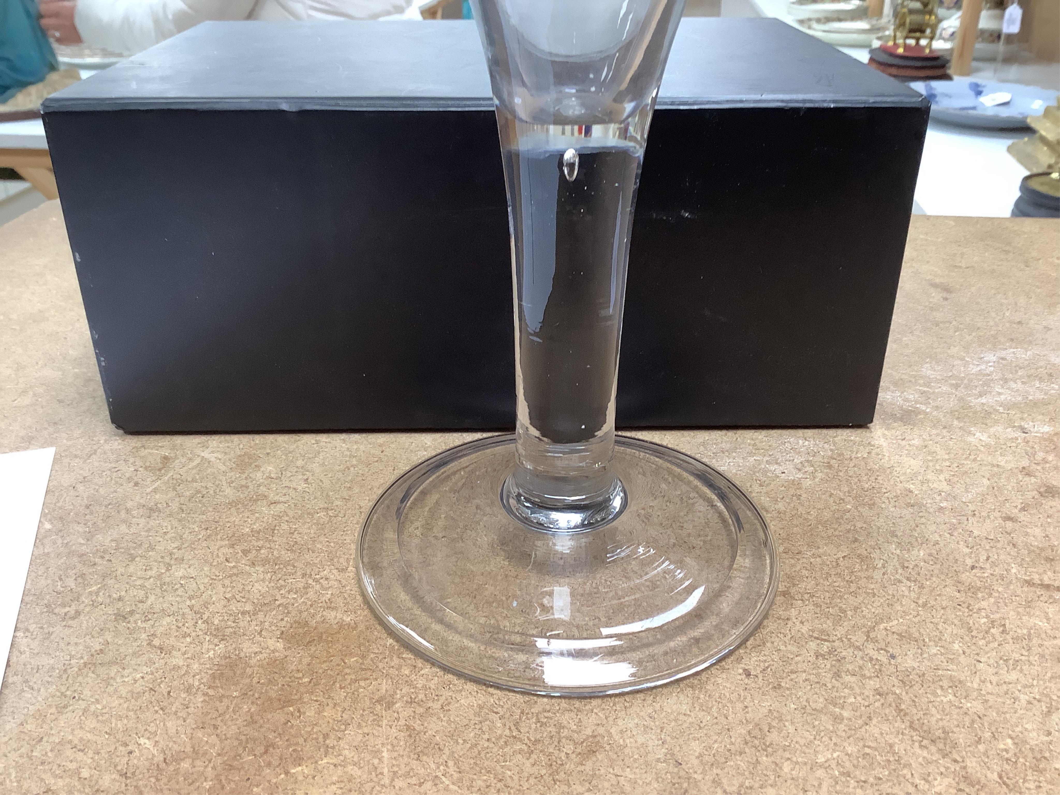 Three late 18th century trumpet glasses, all with plain stems containing tears, tallest 21cm